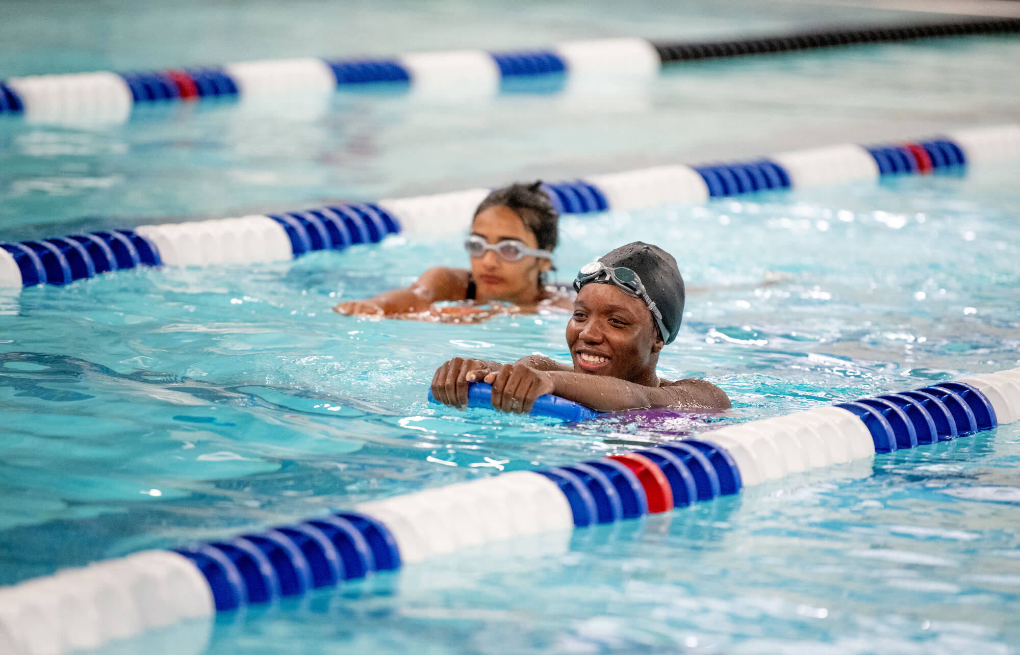 two students learning to swim